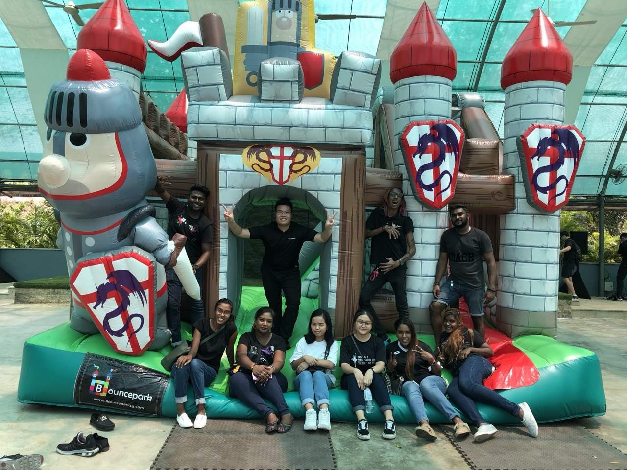 Group in front of a knight bouncy castle